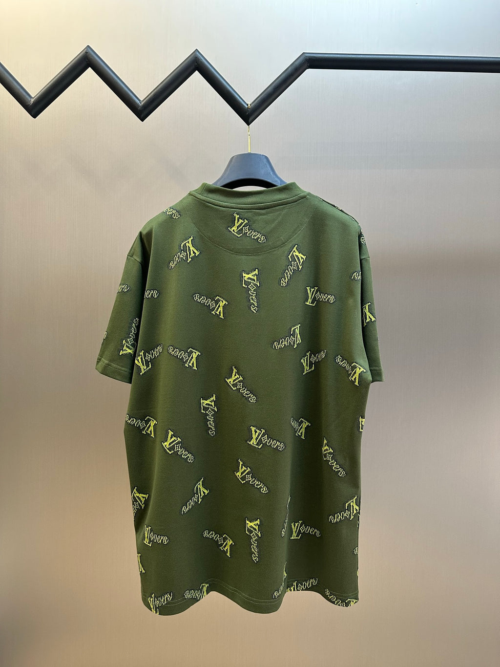 Green short-sleeve crewneck shirt with yellow LV-style logo embroidery on back