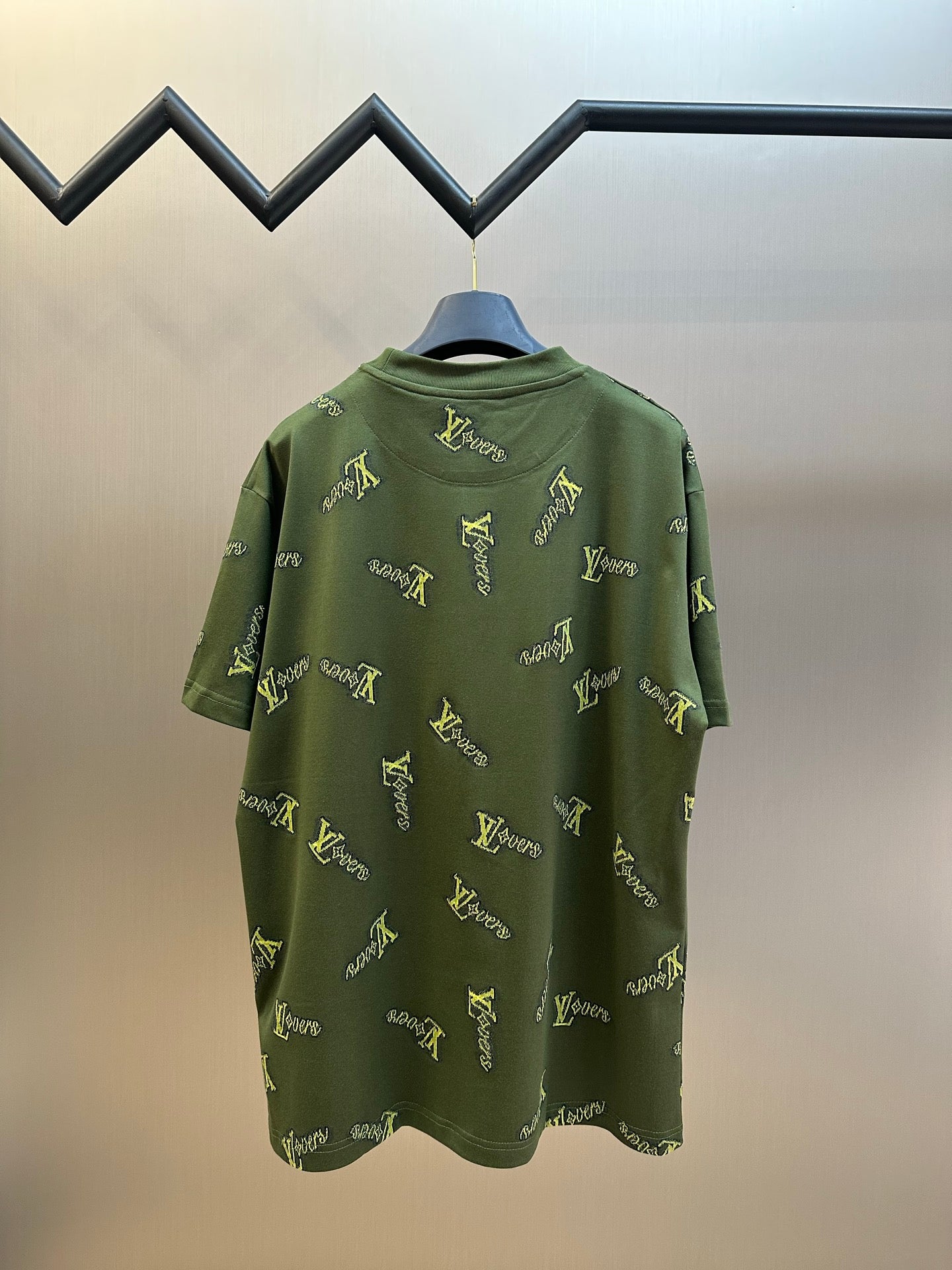Green short-sleeve crewneck shirt with yellow LV-style logo embroidery on back