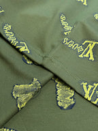 Green shirt with V-shaped seam and yellow LV-style logo embroidery