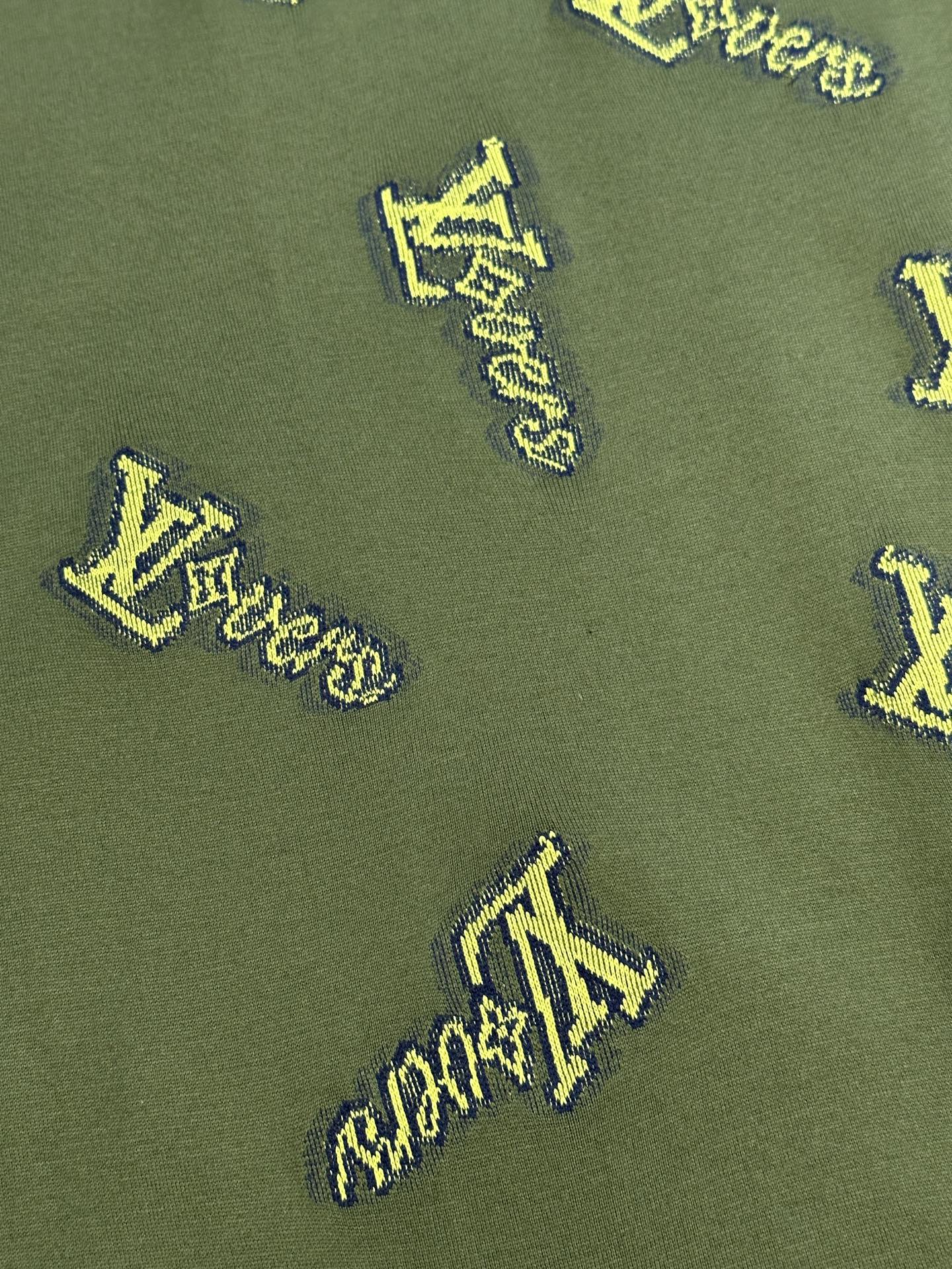 Green shirt fabric with yellow LV-style logo embroidery pattern