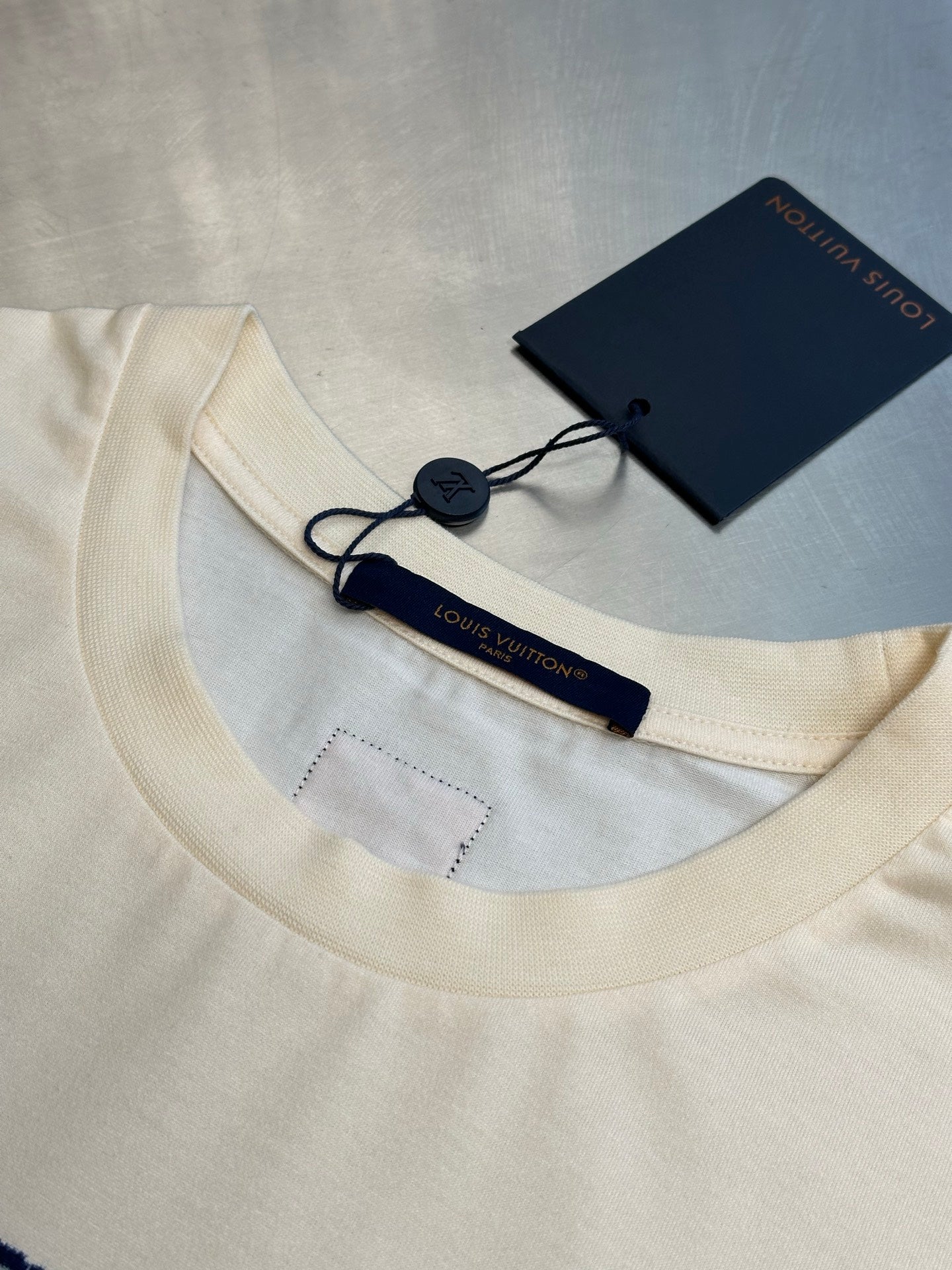 Louis Vuitton cream T-shirt neckline with seam stitching and hanging tag