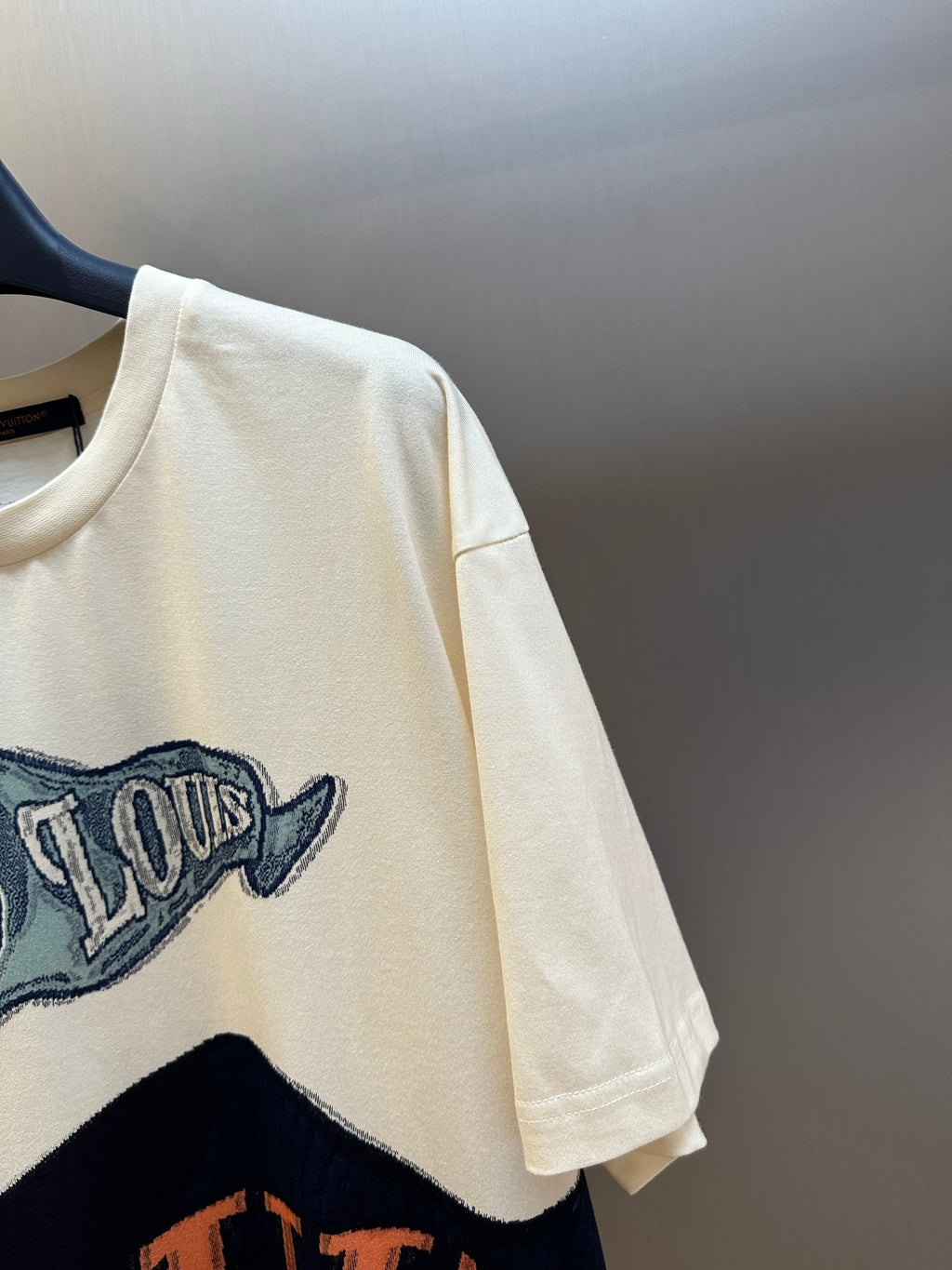 Louis Vuitton graphic T-shirt sleeve in cream with partial graphic print
