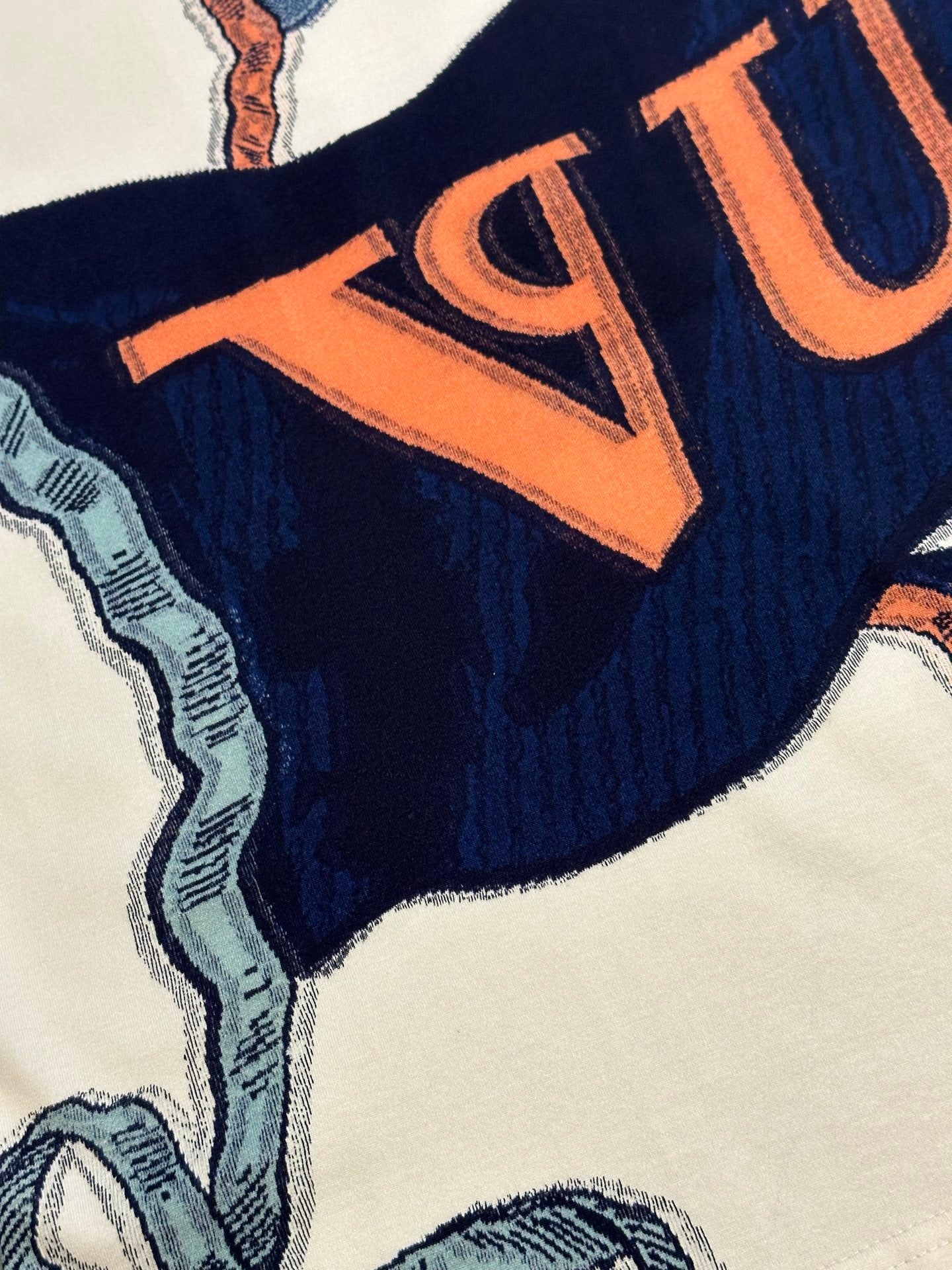 Louis Vuitton graphic T-shirt print with orange lettering on navy fabric