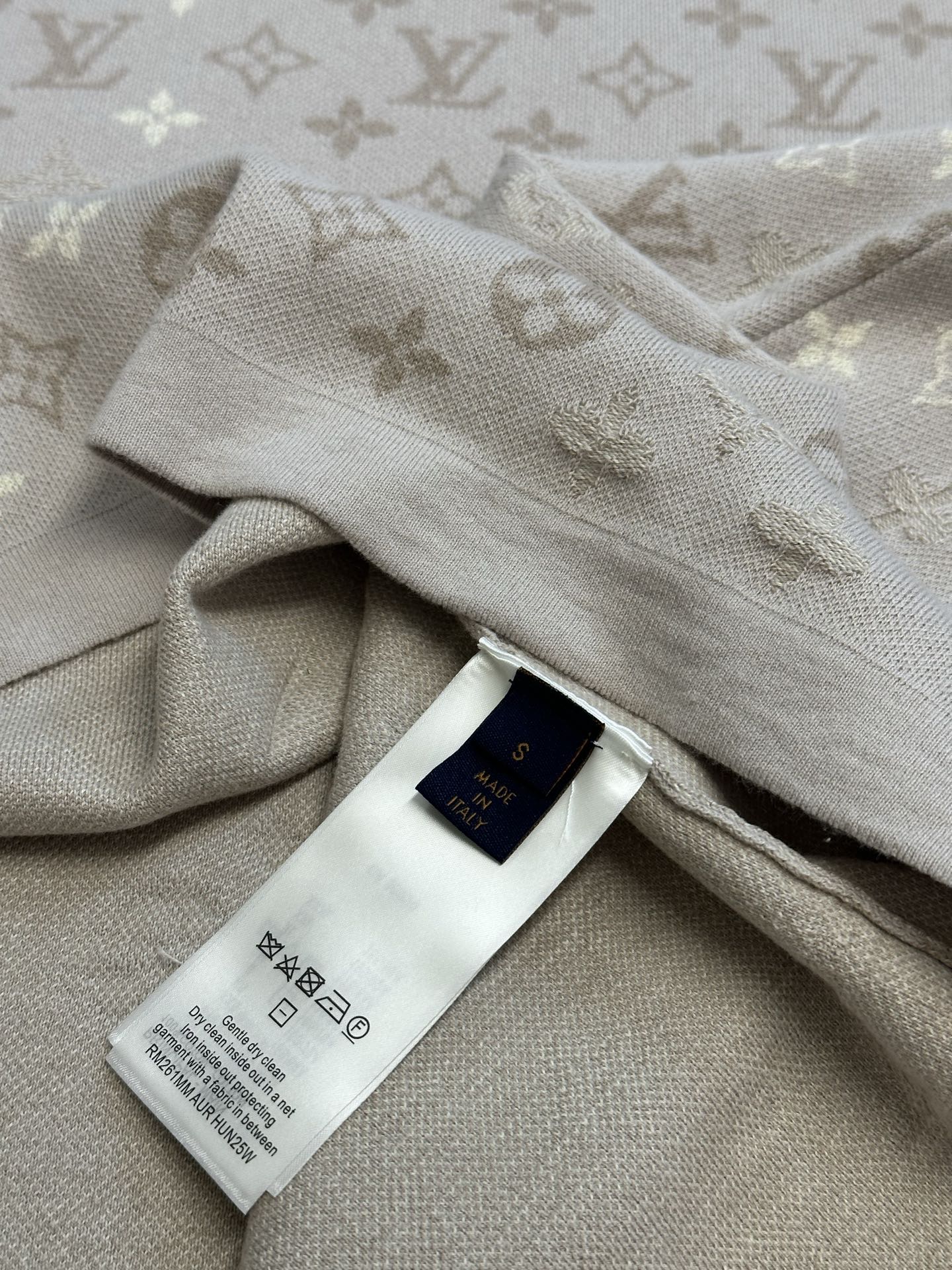 Monogram knit T-shirt with care label on light beige fabric