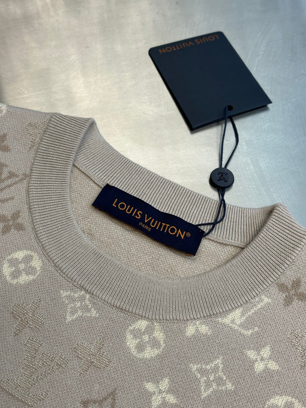 Monogram knit T-shirt neckline with ribbed crew collar and hanging tag