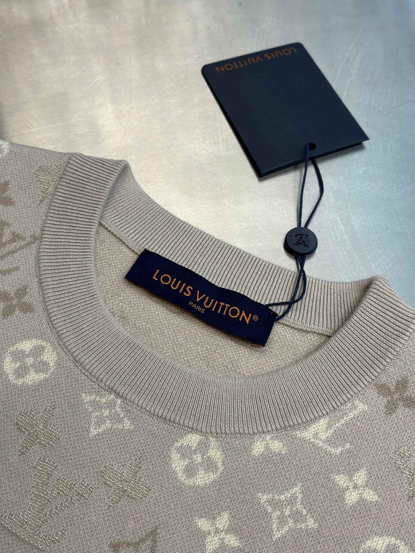 Monogram knit T-shirt neckline with ribbed crew collar and hanging tag