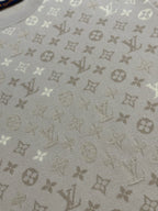 Light beige monogram knit fabric with repeating icons texture