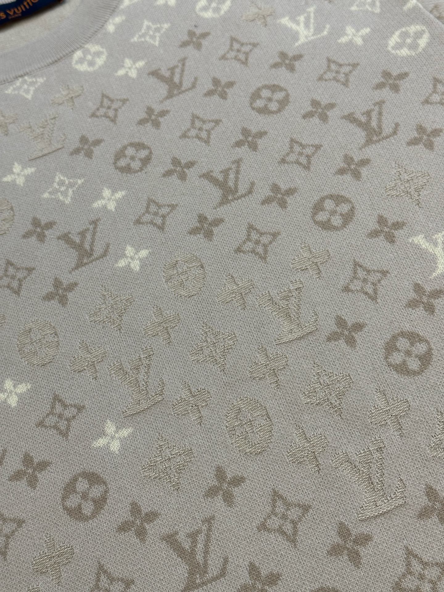 Light beige monogram knit fabric with repeating icons texture