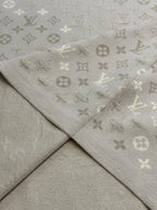 Beige monogram knit T-shirt hem and stitched panel seam detail