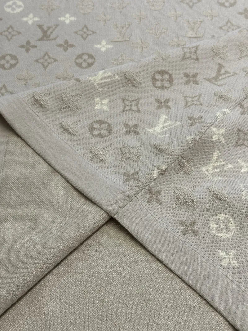 Beige monogram knit T-shirt hem and stitched panel seam detail
