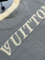 Light blue knit polo shirt with large 'VUITTON' lettering on front