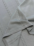 Light blue knit polo placket with stitched details and ribbed hem