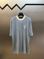 Light blue knit polo shirt with off-white ribbed collar and short sleeves