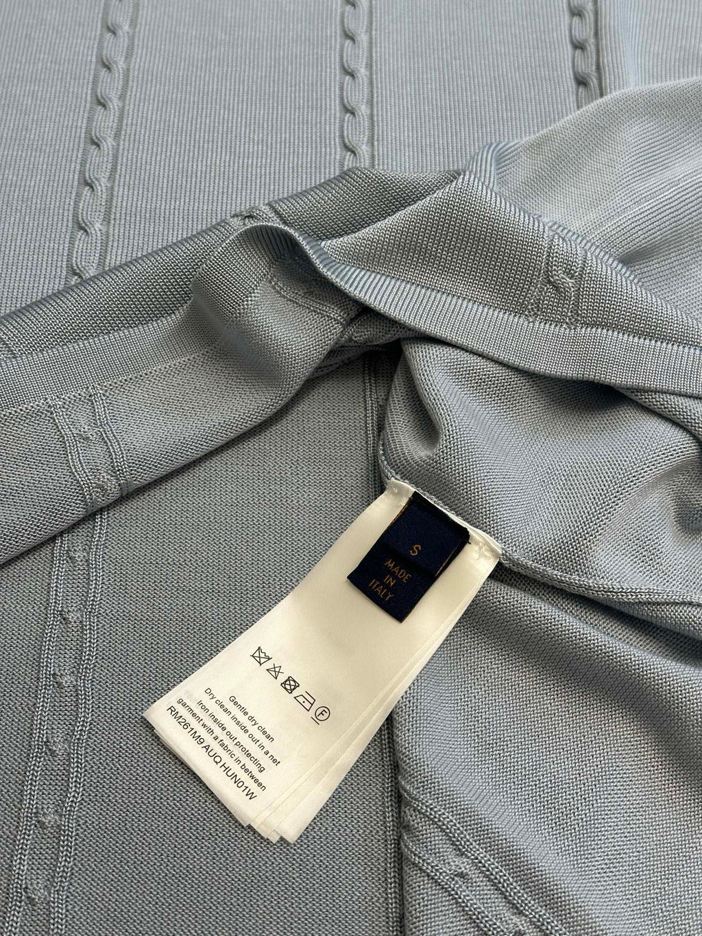 Light blue knit polo with interior neck label and stitched collar
