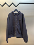 Dark navy zip-up hoodie with drawstring hood and gold zipper pull