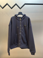 Dark navy zip-up hoodie with drawstring hood and gold zipper pull
