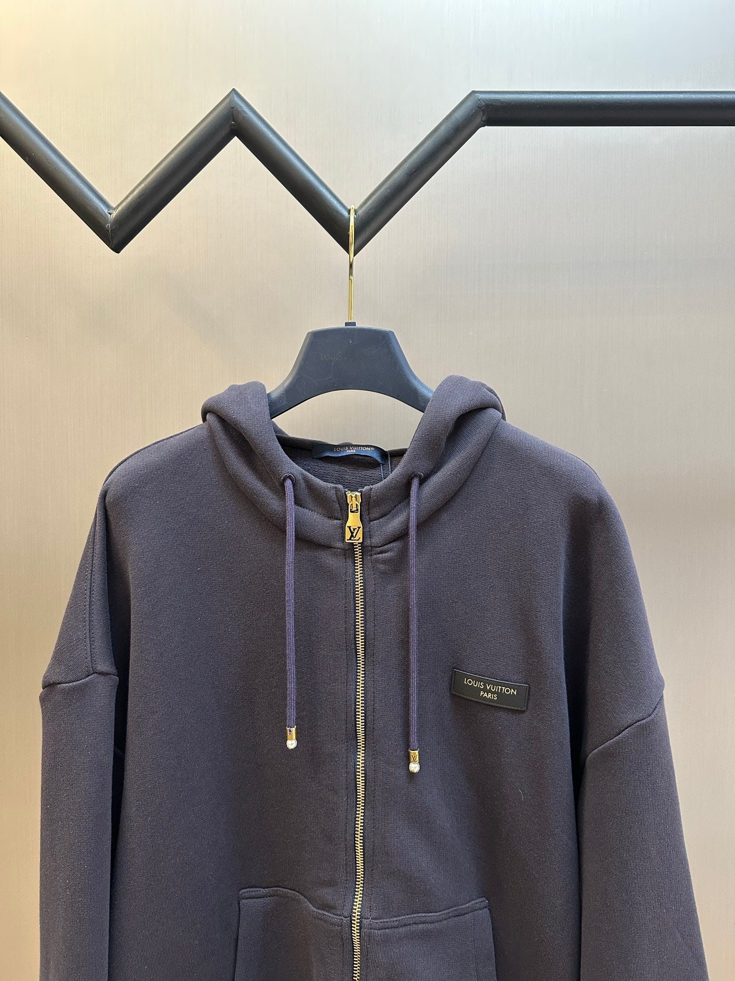 Dark navy zip-up hoodie with hood, chest pocket, and Louis Vuitton Paris patch