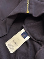 Dark navy hoodie with care and size tags near the zip opening