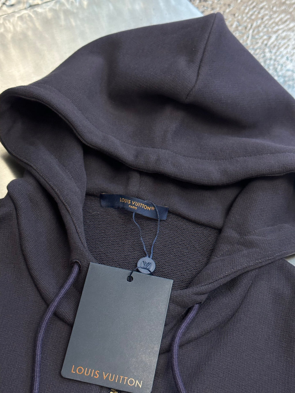 Dark navy hoodie hood with Louis Vuitton Paris neck tag inside