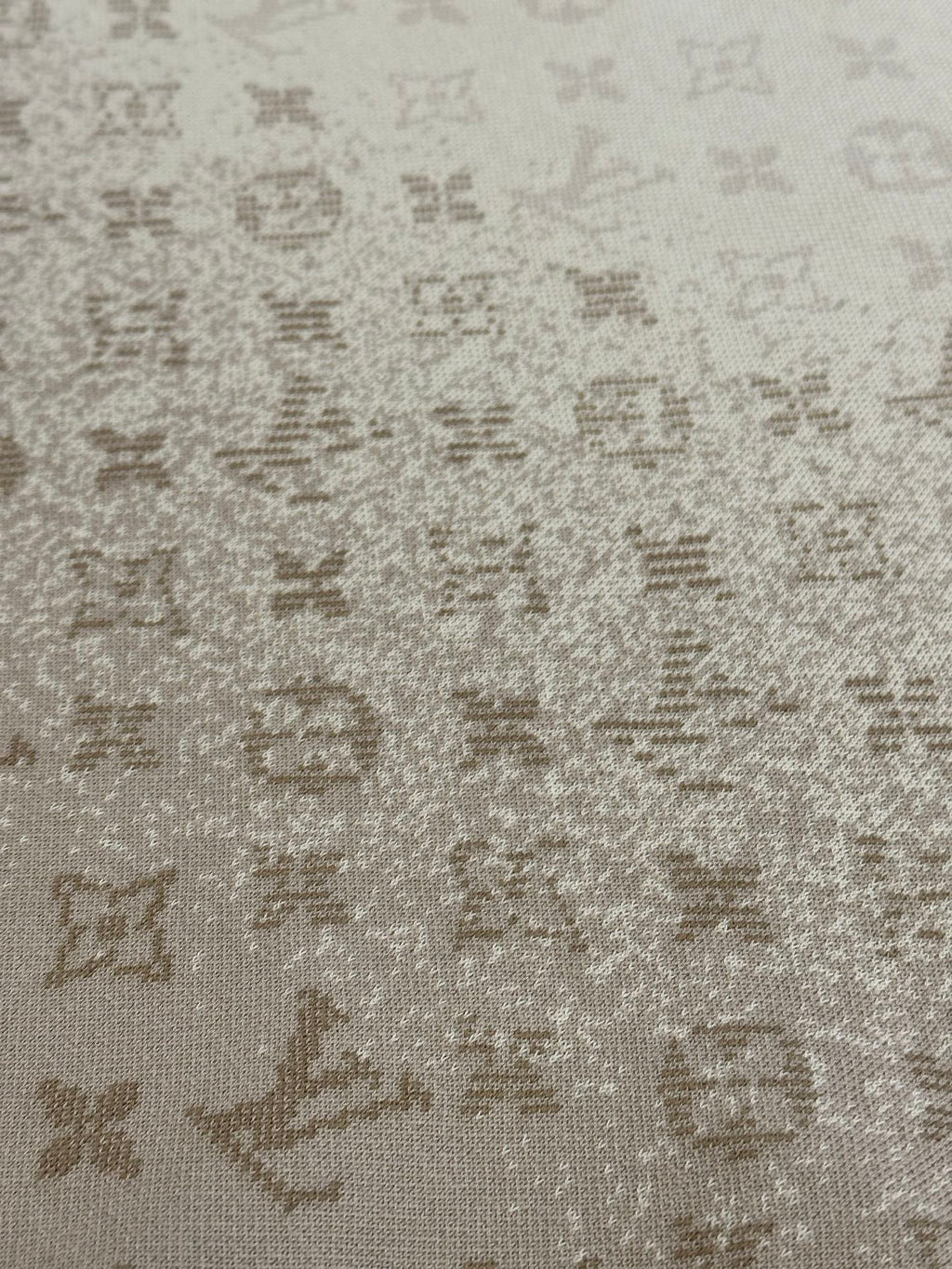 Light beige knit fabric with scattered Louis Vuitton monogram motifs