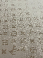 Light beige knit fabric with scattered Louis Vuitton monogram motifs