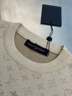 Light beige crewneck sweater with ribbed collar and Louis Vuitton logo tag