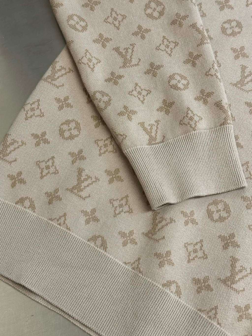 Light beige knit sweater with ribbed cuffs and all-over Louis Vuitton monogram