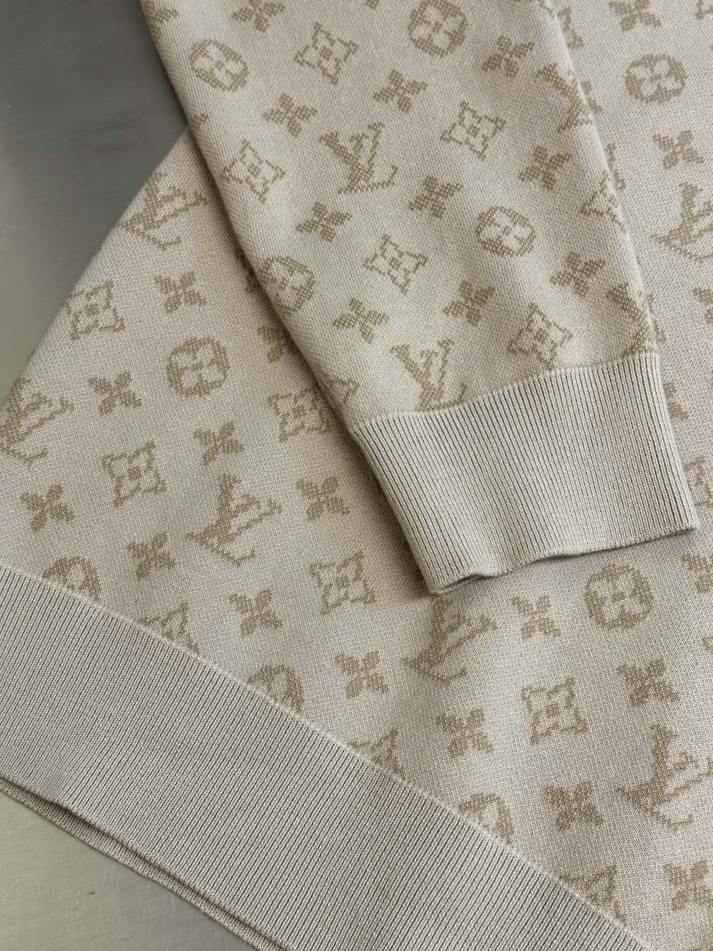 Light beige knit sweater with ribbed cuffs and all-over Louis Vuitton monogram