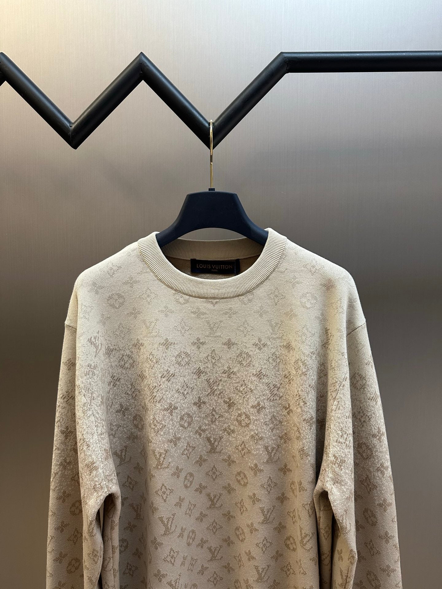 Light beige crewneck sweater with small all-over monogram pattern, long sleeves