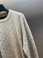 Light beige sweater sleeve with all-over Louis Vuitton monogram knit