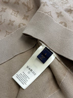 Light beige sweater care label at side seam with Louis Vuitton logo