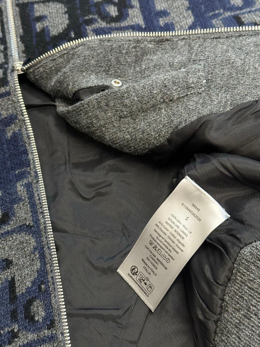 Logo knit zip jacket inside lining with care label and front zipper