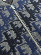 Logo knit zip jacket zipper close-up over blue-gray pattern