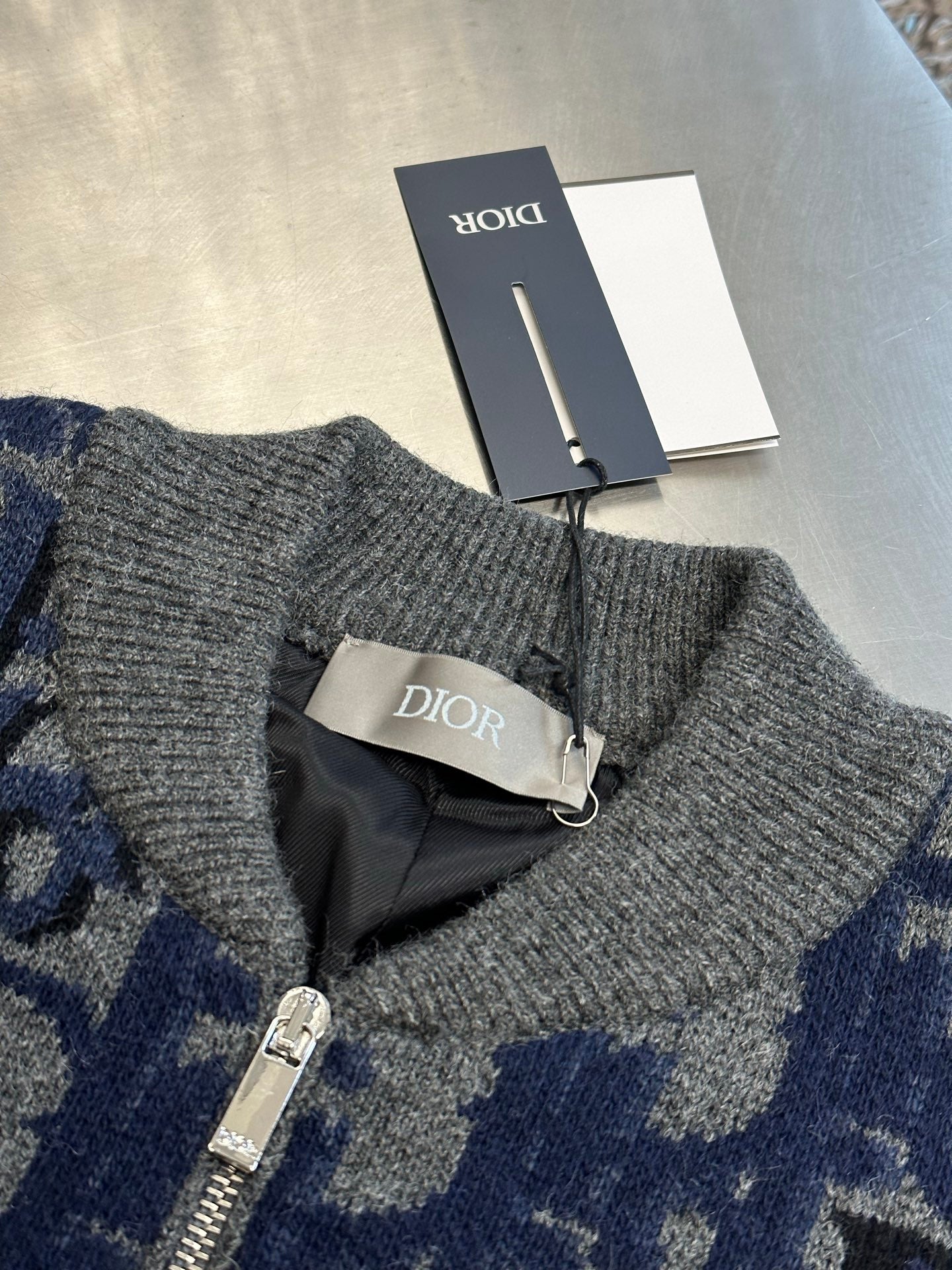 Logo knit zip jacket collar detail, gray ribbed trim and zipper pull