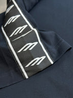 Close-up of sleeve logo-tape stripe on dark navy T-shirt