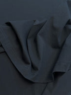 Crewneck T-shirt fabric close-up with curved neckline seam