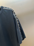 Crewneck T-shirt side view with dark navy logo-tape stripe on sleeve