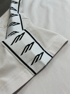 White sleeve cuff with black logo stripe trim