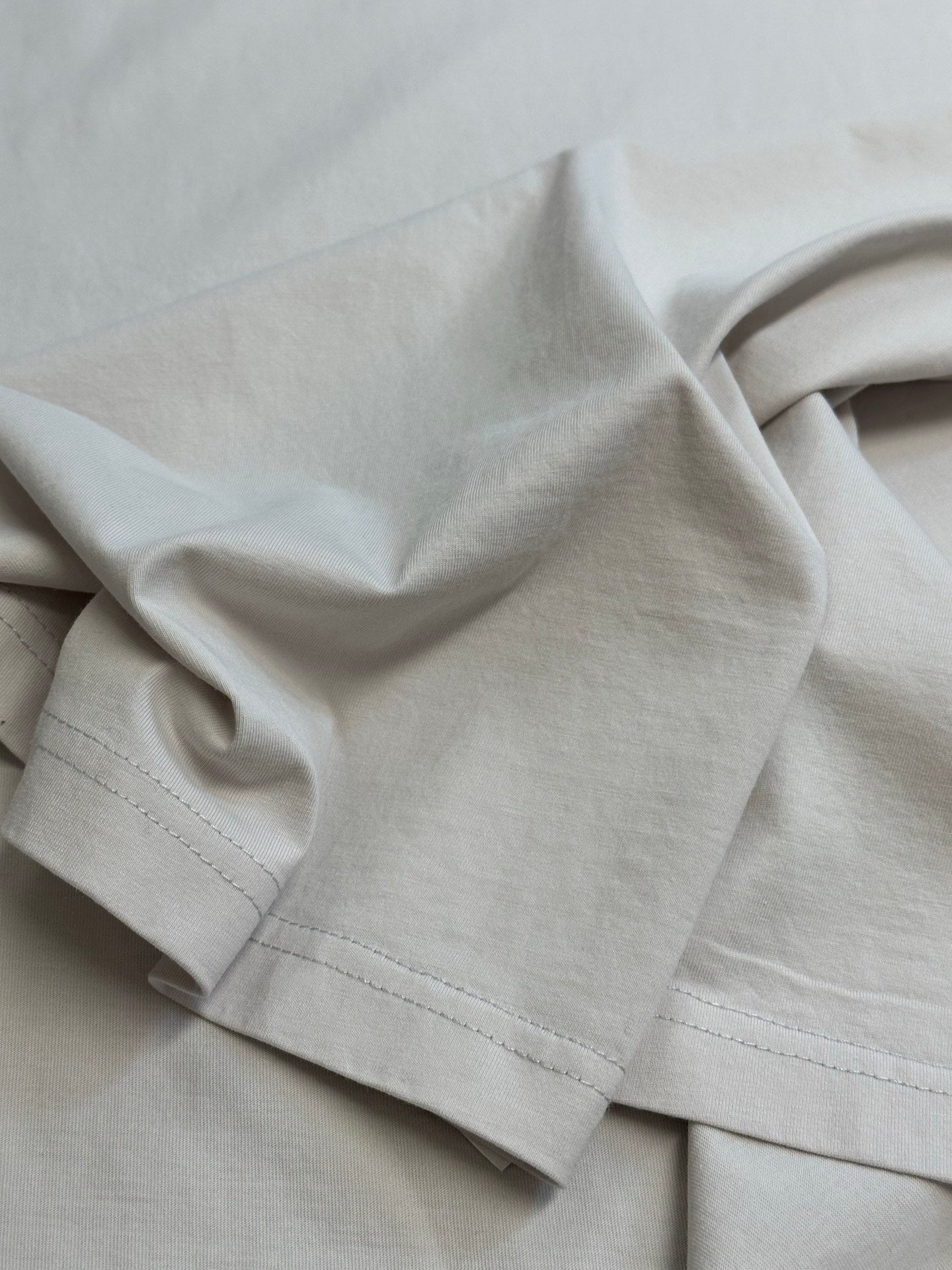 White T-shirt fabric and stitched hem detail
