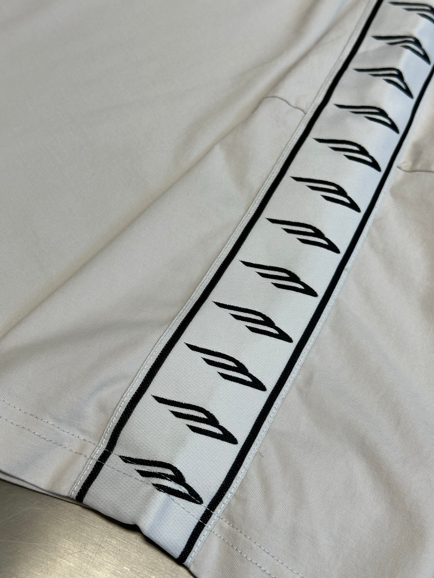White sleeve panel with black Balenciaga logo graphic trim