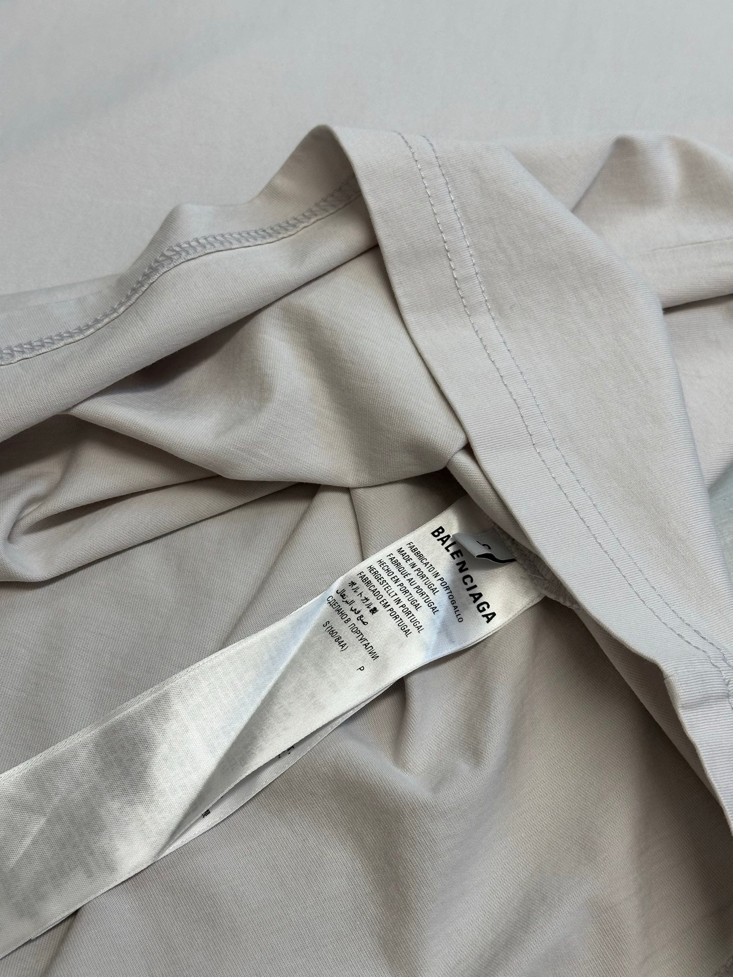 Folded white T-shirt fabric with small Balenciaga label