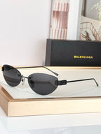 Balenciaga sunglasses with black frame and dark lenses, round oversized style