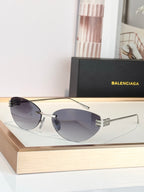 Balenciaga sunglasses with dark lenses and silver frame, round aviator style