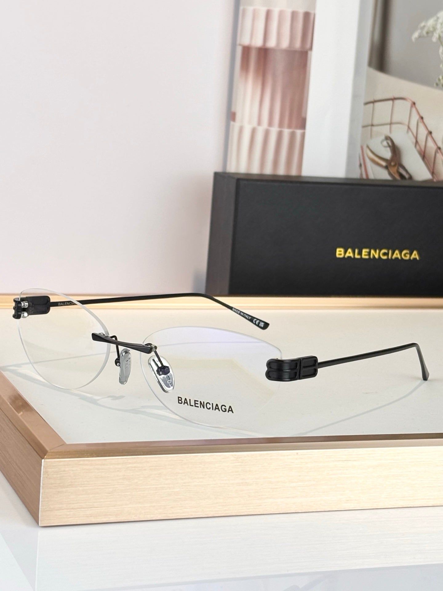 Balenciaga sunglasses with gold frame and clear lenses, metal hinge detail