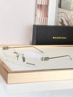 Balenciaga sunglasses with silver frame and clear lenses, curved metal arms