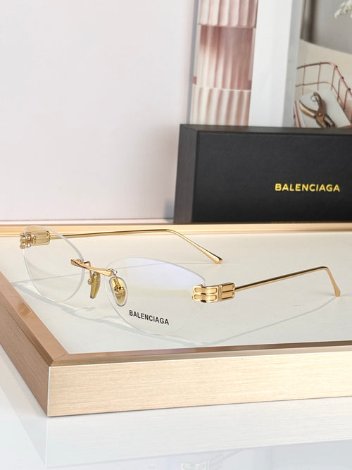 Balenciaga sunglasses with gold frame and clear lenses, metal bridge detail