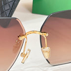 Bottega Veneta sunglasses close-up: brown tinted lenses and gold-tone hinge