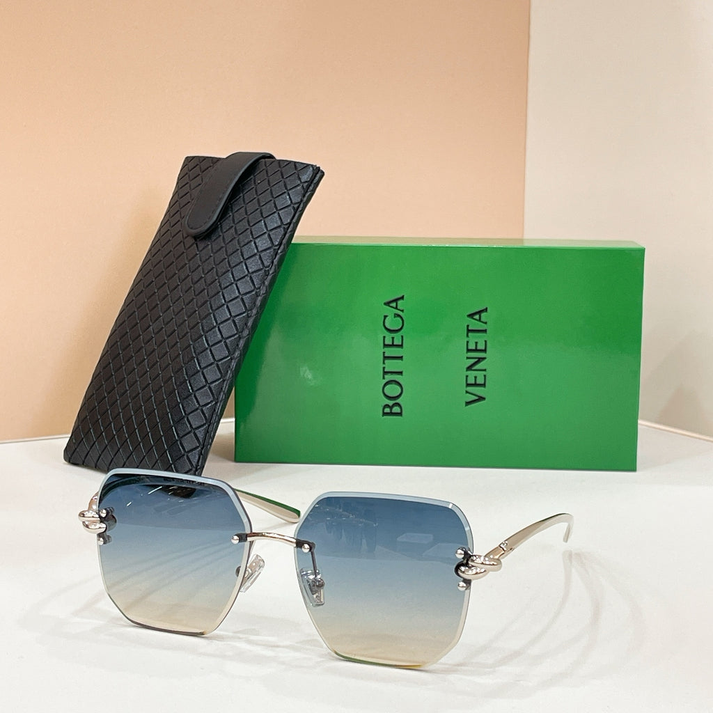 Bottega Veneta sunglasses with gold-tone frame and blue tinted lenses