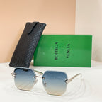 Bottega Veneta sunglasses with gold-tone frame and blue tinted lenses