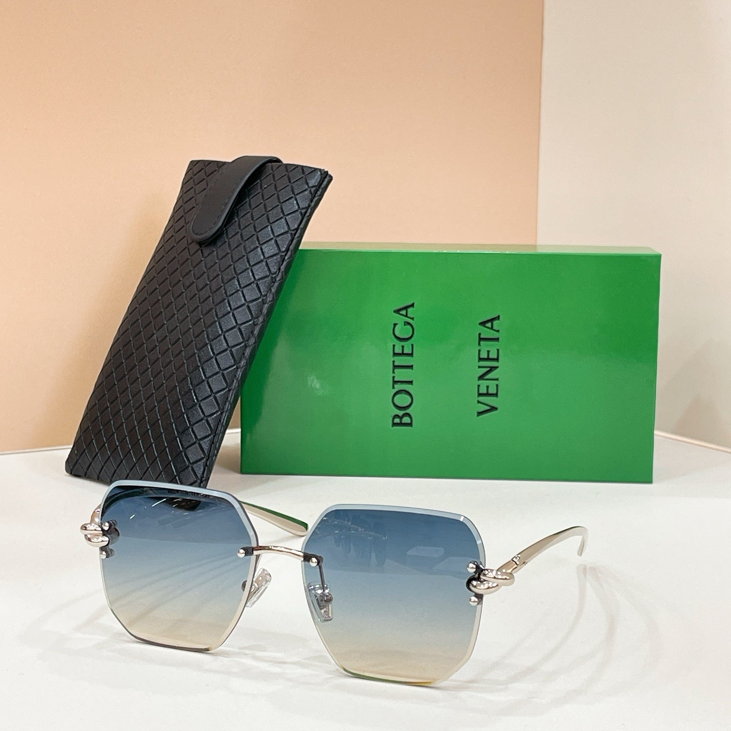 Bottega Veneta sunglasses with gold-tone frame and blue tinted lenses